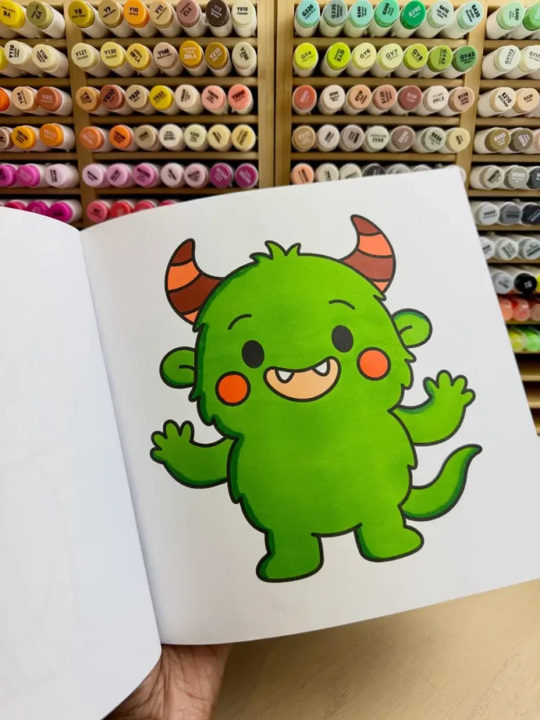 Cute monster coloring page completed with vibrant green markers in a beginner-friendly adult coloring book.